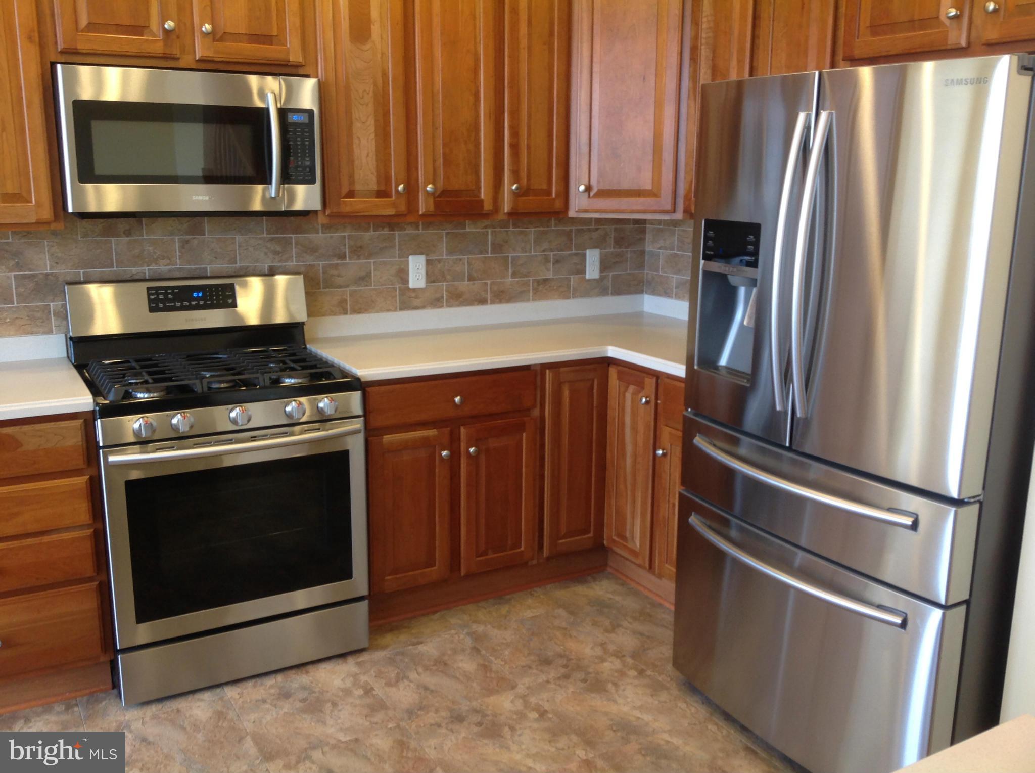 a kitchen with stainless steel appliances and cabinets