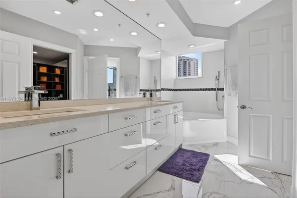 a bathroom with a bathtub and a shower