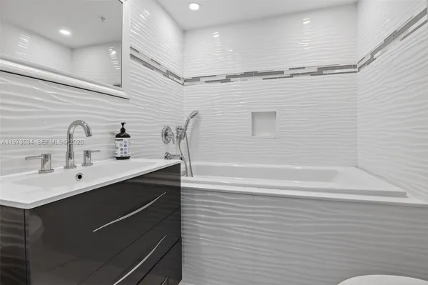 a view of a ocean with city from a tub