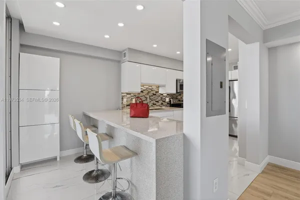 a kitchen with a refrigerator a stove top oven and cabinets