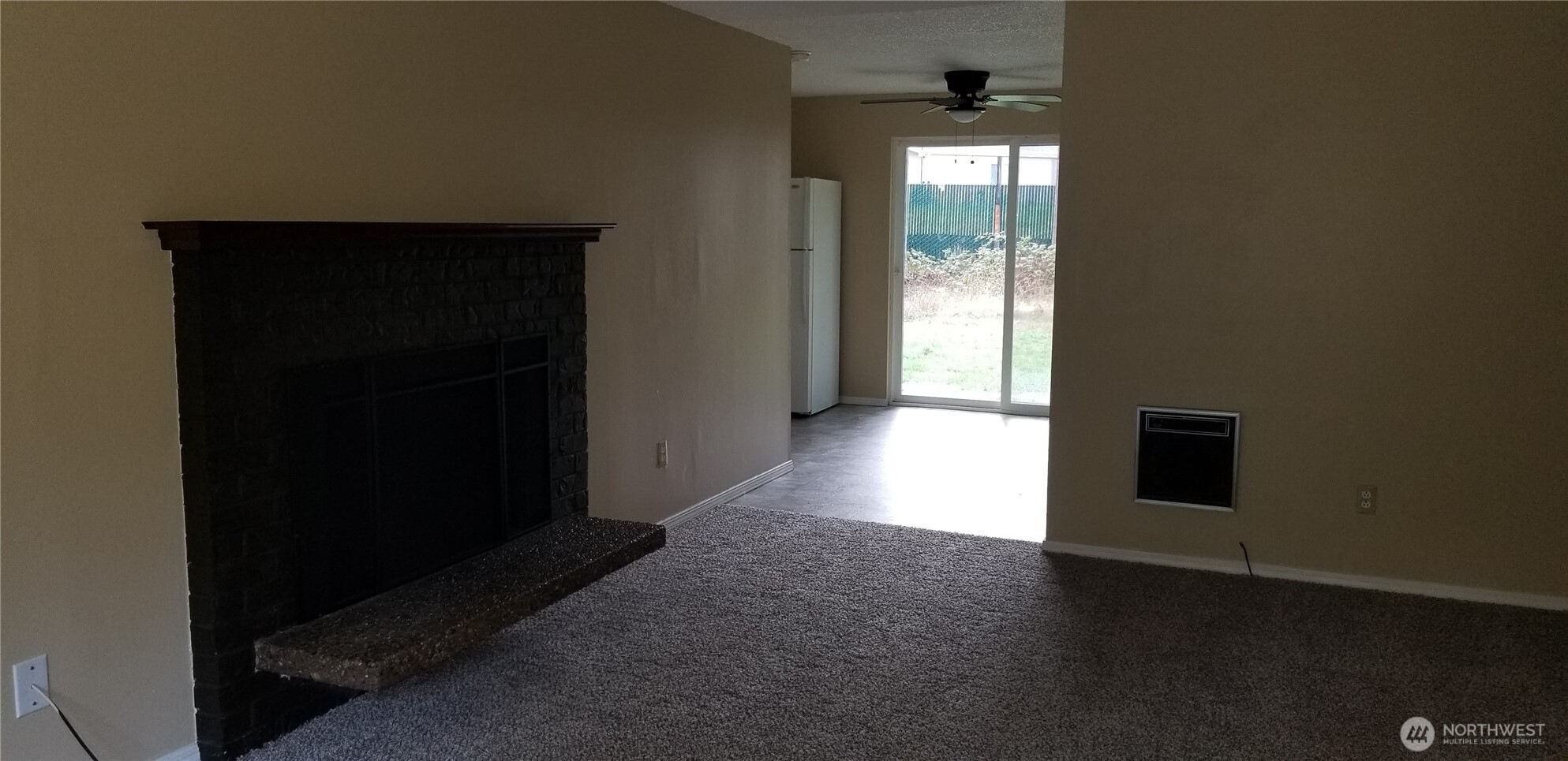 9210-9212 204th Street East Graham, WA 98338 - Photo 3 of 16 wooden floor in an empty room with a window