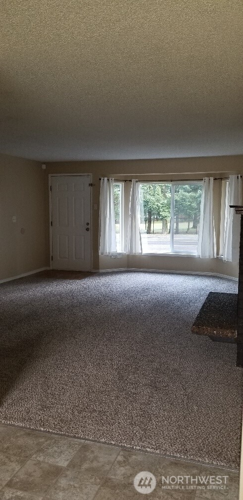 9210-9212 204th Street East Graham, WA 98338 - Photo 4 of 16 a view of an empty room with a window