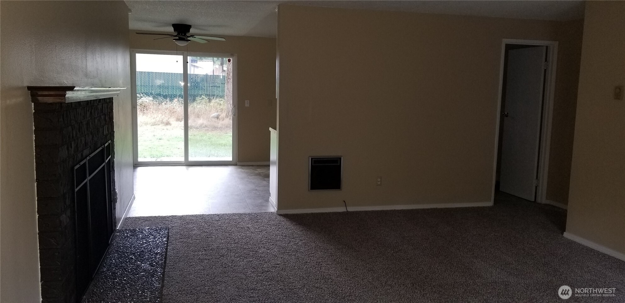 9210-9212 204th Street East Graham, WA 98338 - Photo 5 of 16 a view of empty room with wooden floor and fan