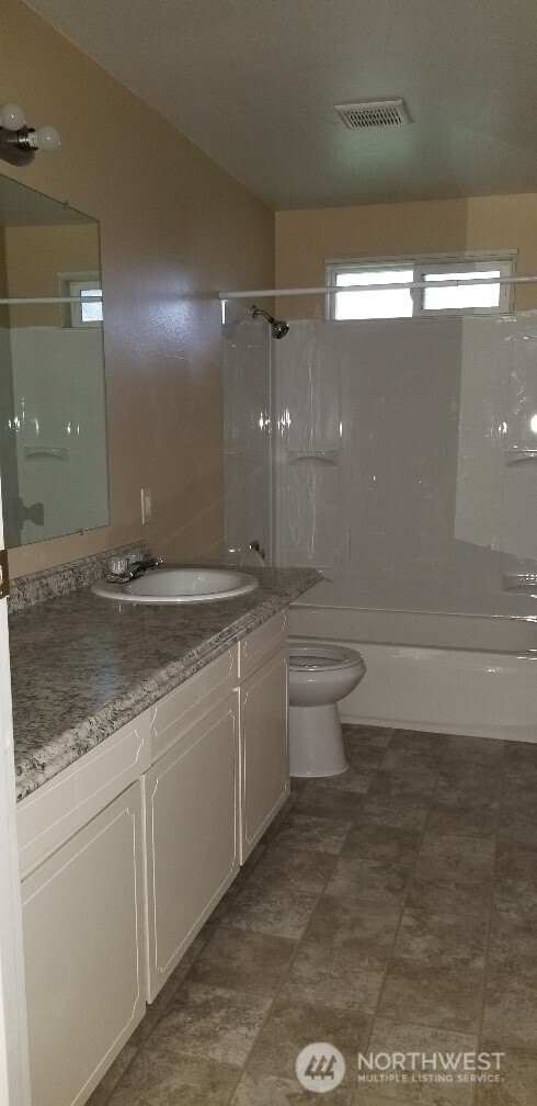 9210-9212 204th Street East Graham, WA 98338 - Photo 7 of 16 a bathroom with a sink and mirror