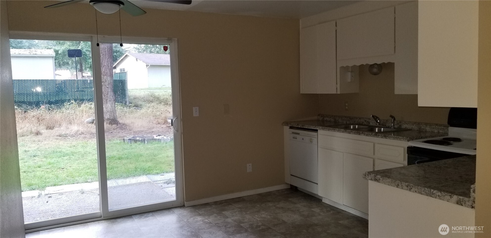 9210-9212 204th Street East Graham, WA 98338 - Photo 10 of 16 a kitchen with a stove a sink and a refrigerator