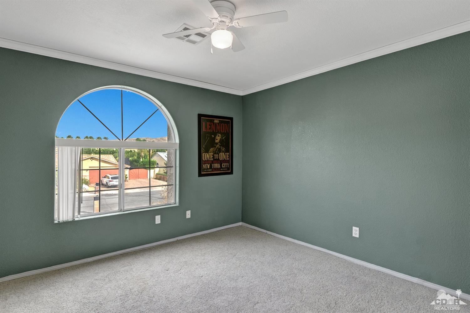 68889 Risueno Road Cathedral City, CA 92234 - Photo 18 of 29 an empty room with a window and a ceiling fan
