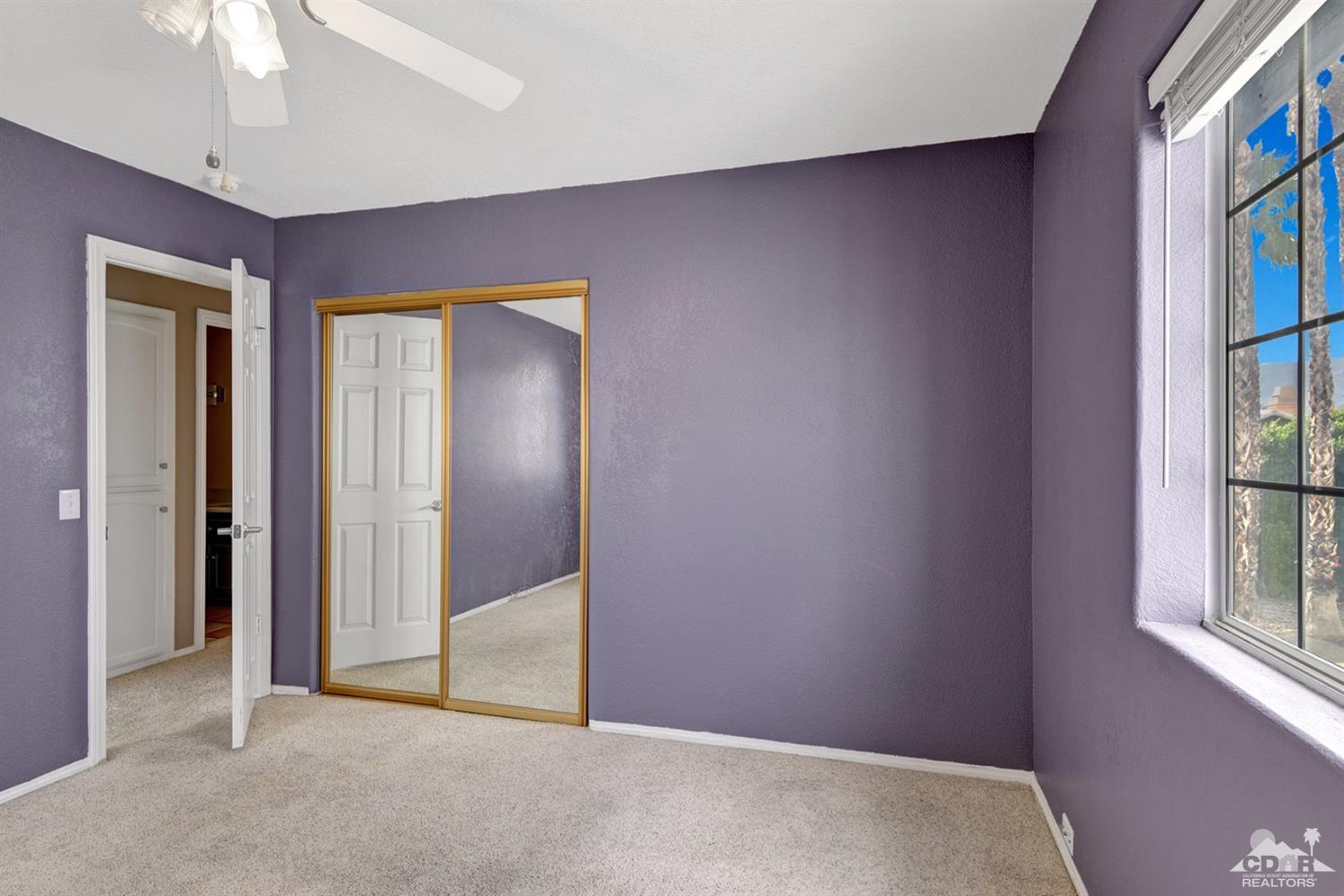 68889 Risueno Road Cathedral City, CA 92234 - Photo 22 of 29 an empty room with windows and fan