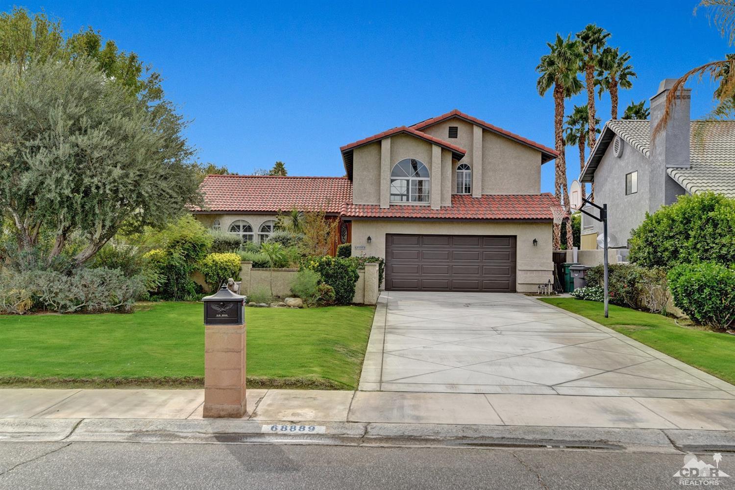 68889 Risueno Road Cathedral City, CA 92234 - Photo 29 of 29 a front view of a house with a yard and garage