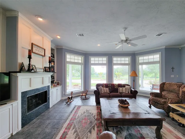 a large kitchen with kitchen island a sink a stove a counter top space and cabinets