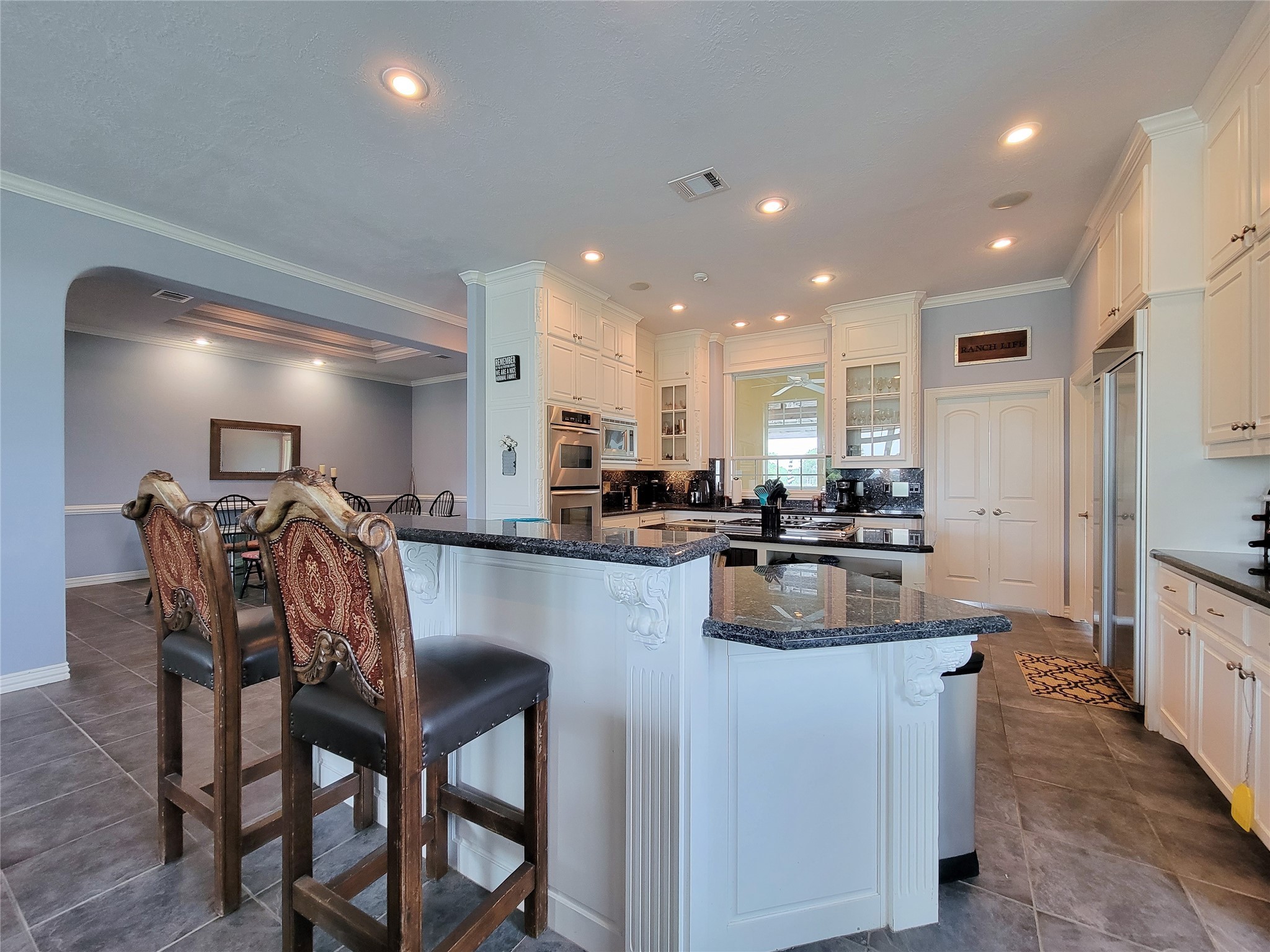 939 Old Nelsonville Road Bellville, TX 77418 - Photo 17 of 50 a kitchen with counter space dining table and stainless steel appliances