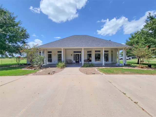 a front view of house with yard and green space