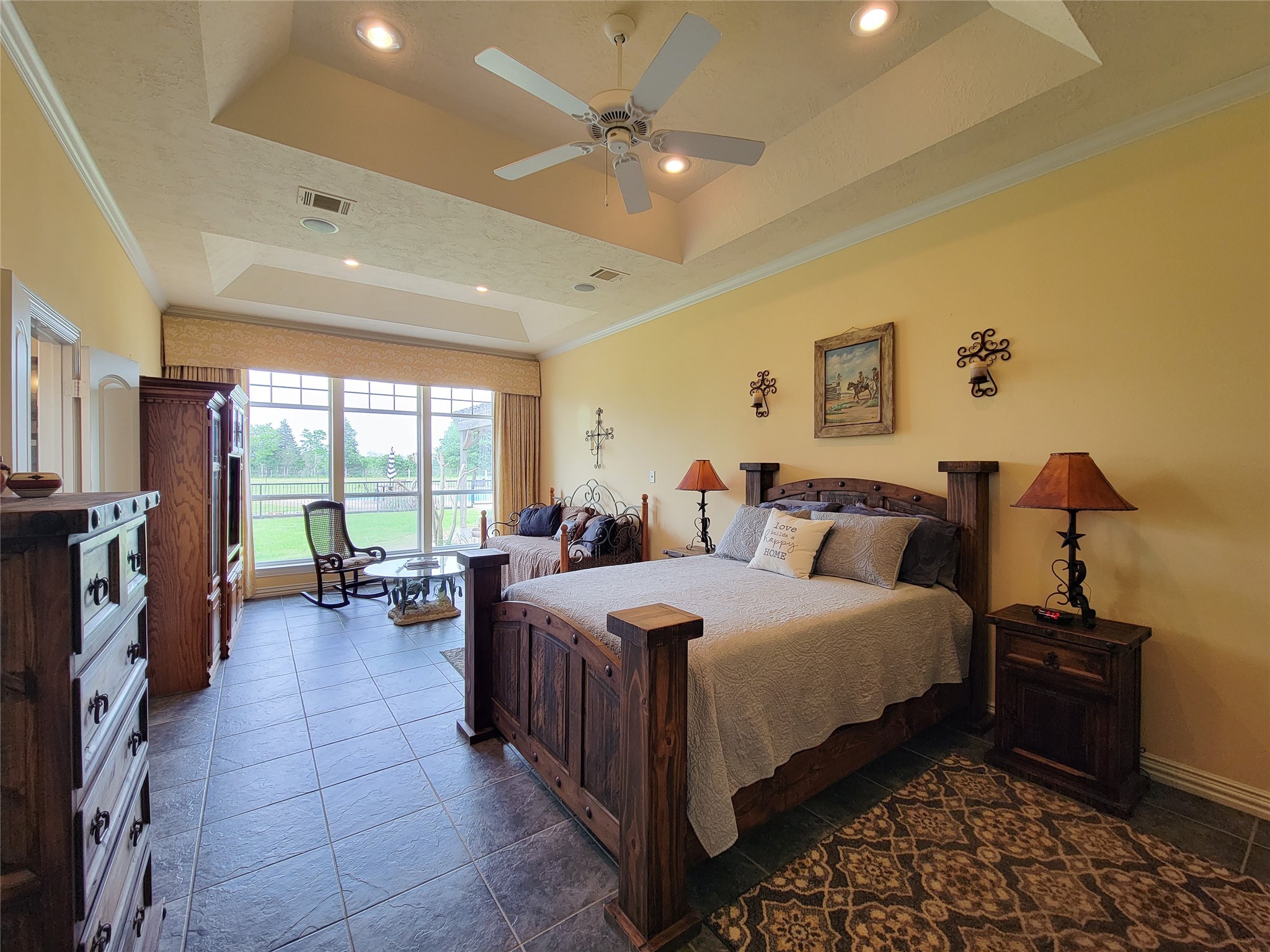 939 Old Nelsonville Road Bellville, TX 77418 - Photo 26 of 50 a large bedroom with a bed and a chandelier