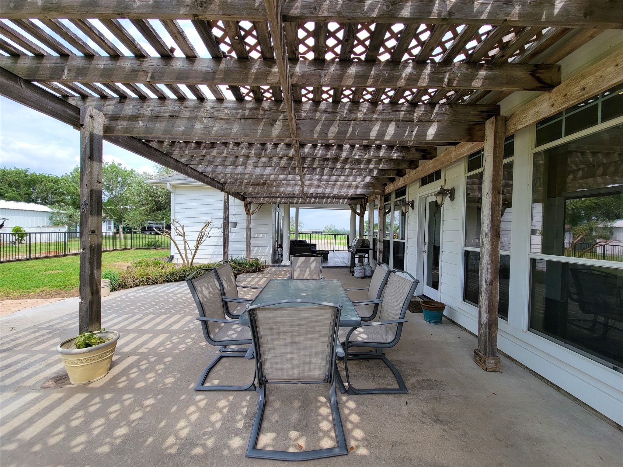 939 Old Nelsonville Road Bellville, TX 77418 - Photo 39 of 50 a view of a patio with a table chairs and a backyard