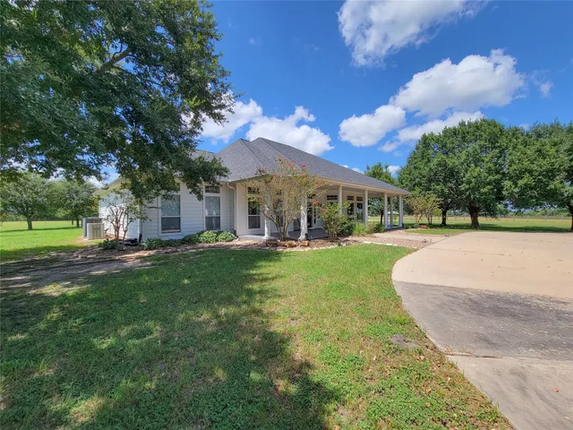 a living room with fireplace furniture and a large window