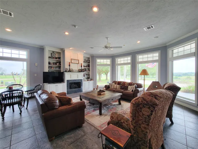 a living room with furniture fireplace and a flat screen tv