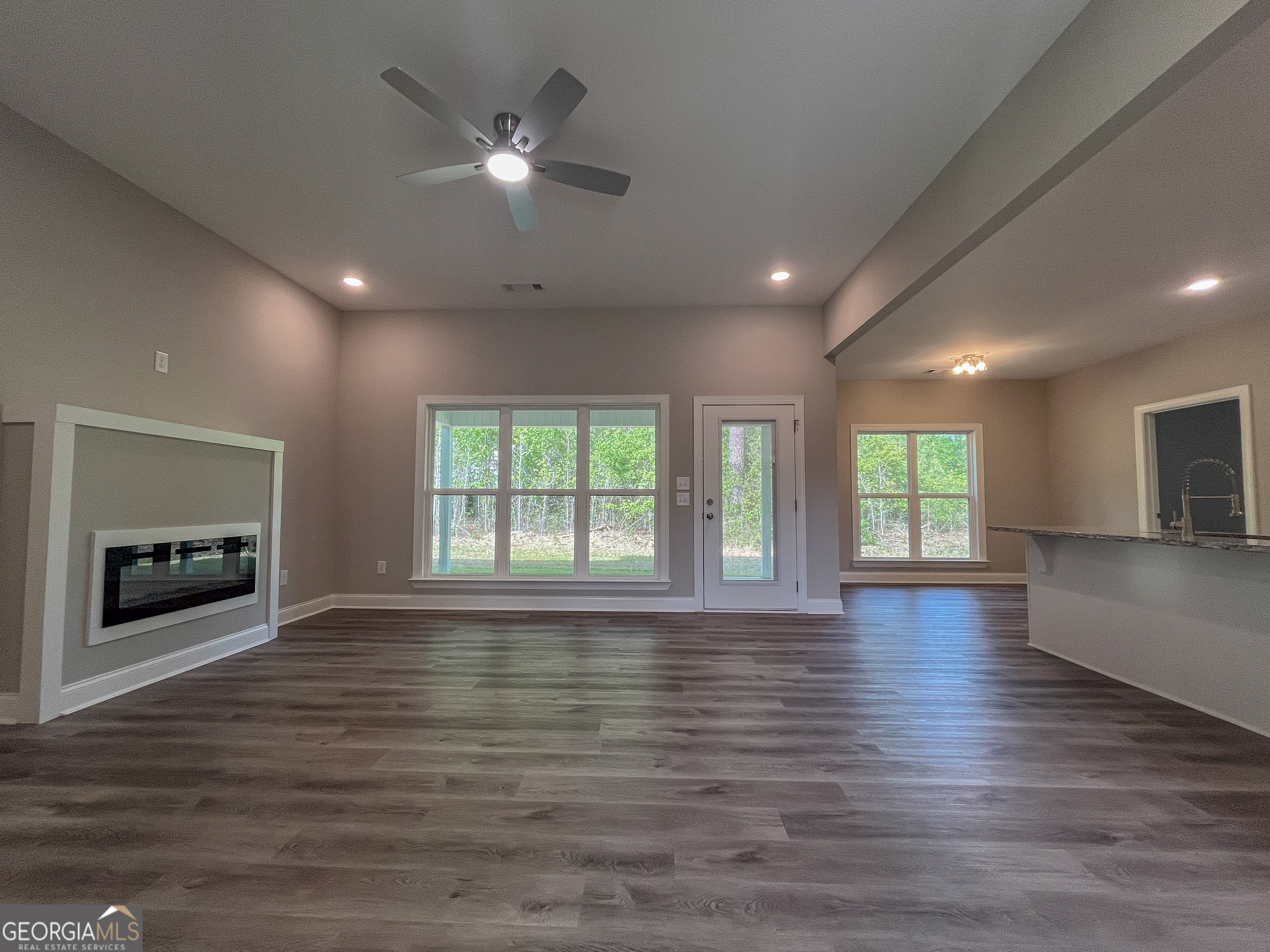 711 Flanders Lane Dublin, GA 31021 - Photo 6 of 49 an empty room with wooden floor and windows