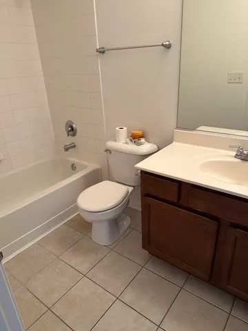 a bathroom with a toilet a sink and a mirror