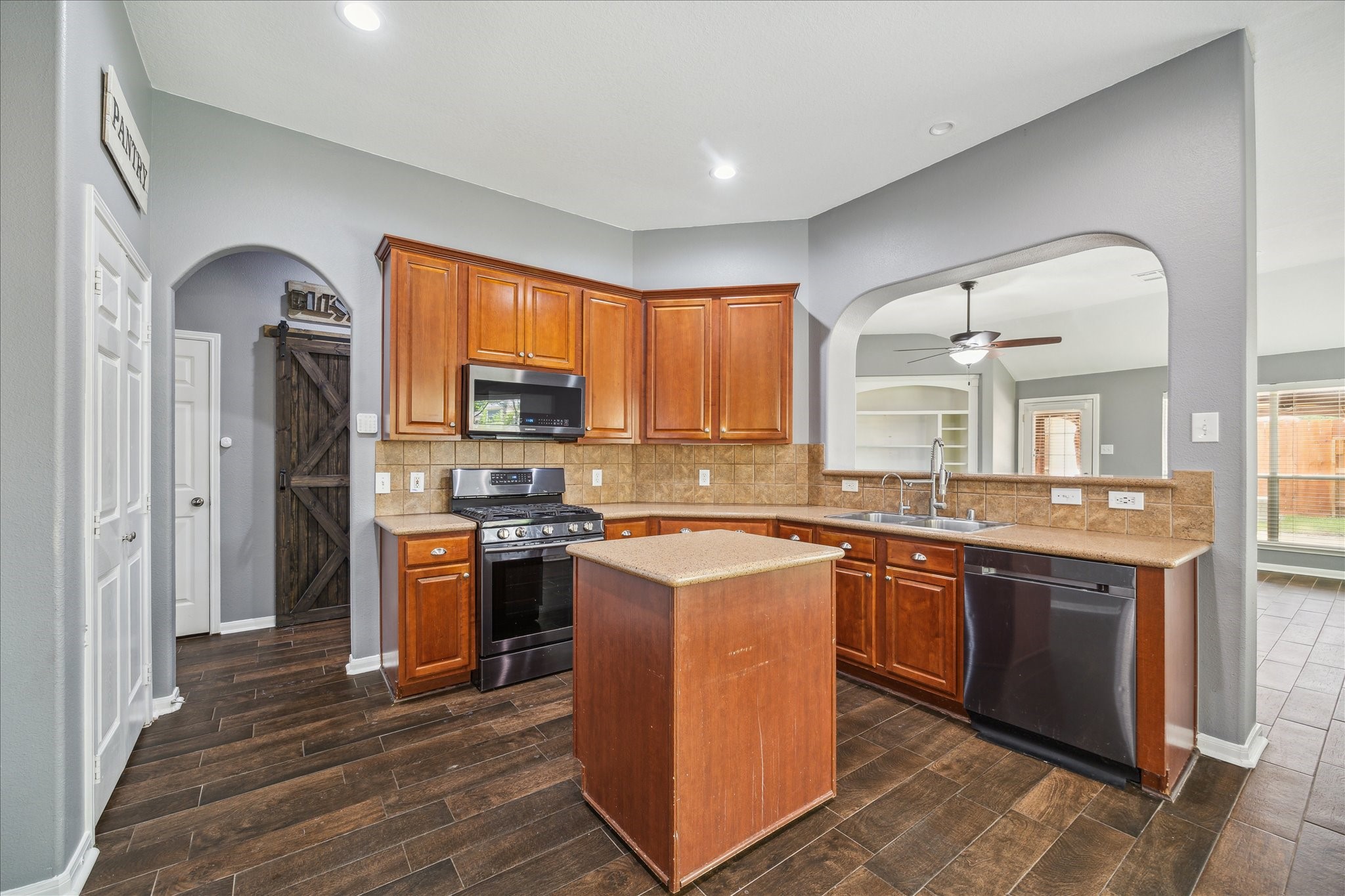 20910 Sandy Briar Court Spring, TX 77379 - Photo 15 of 28 a kitchen with stainless steel appliances granite countertop wooden cabinets a sink and a stove