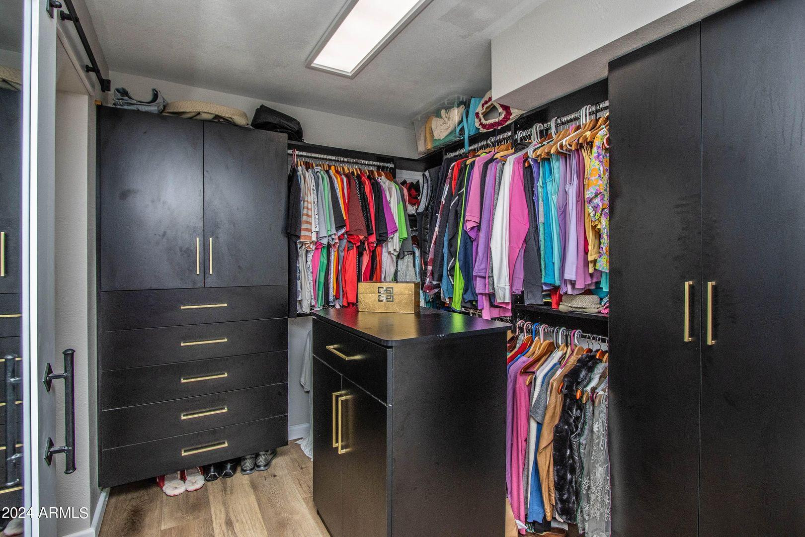 7401 North Scottsdale Road, Unit 3 Paradise Valley, AZ 85253 - Photo 12 of 29 a view of walk in closet with clothes and shoes