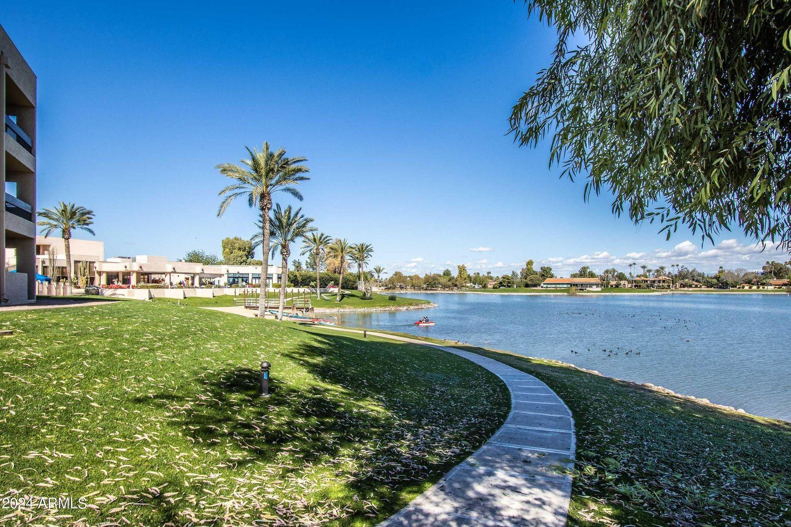 7401 North Scottsdale Road, Unit 3 Paradise Valley, AZ 85253 - Photo 20 of 29 a view of a lake with houses in the back