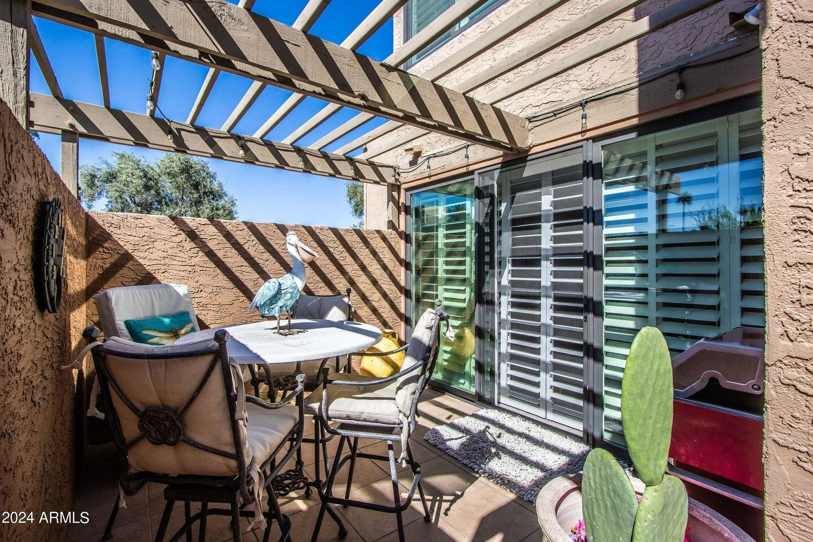 7401 North Scottsdale Road, Unit 3 Paradise Valley, AZ 85253 - Photo 22 of 29 a backyard of a house with table and chairs