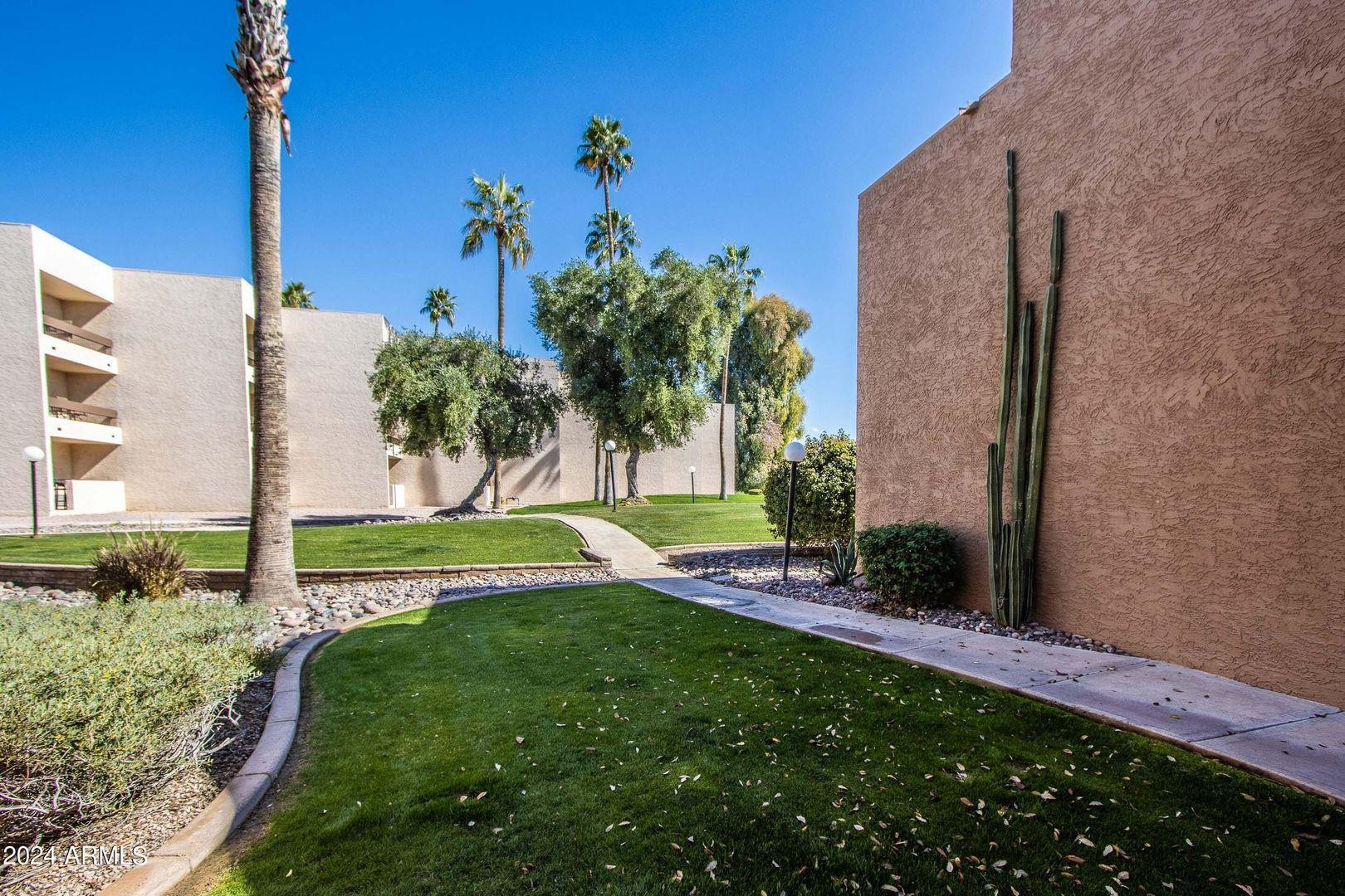 7401 North Scottsdale Road, Unit 3 Paradise Valley, AZ 85253 - Photo 24 of 29 a view of a garden with a building in the background