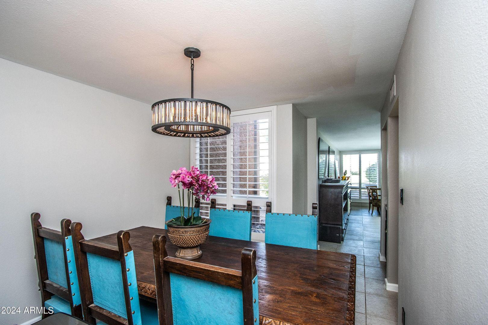 7401 North Scottsdale Road, Unit 3 Paradise Valley, AZ 85253 - Photo 6 of 29 a dining room with furniture and chandelier