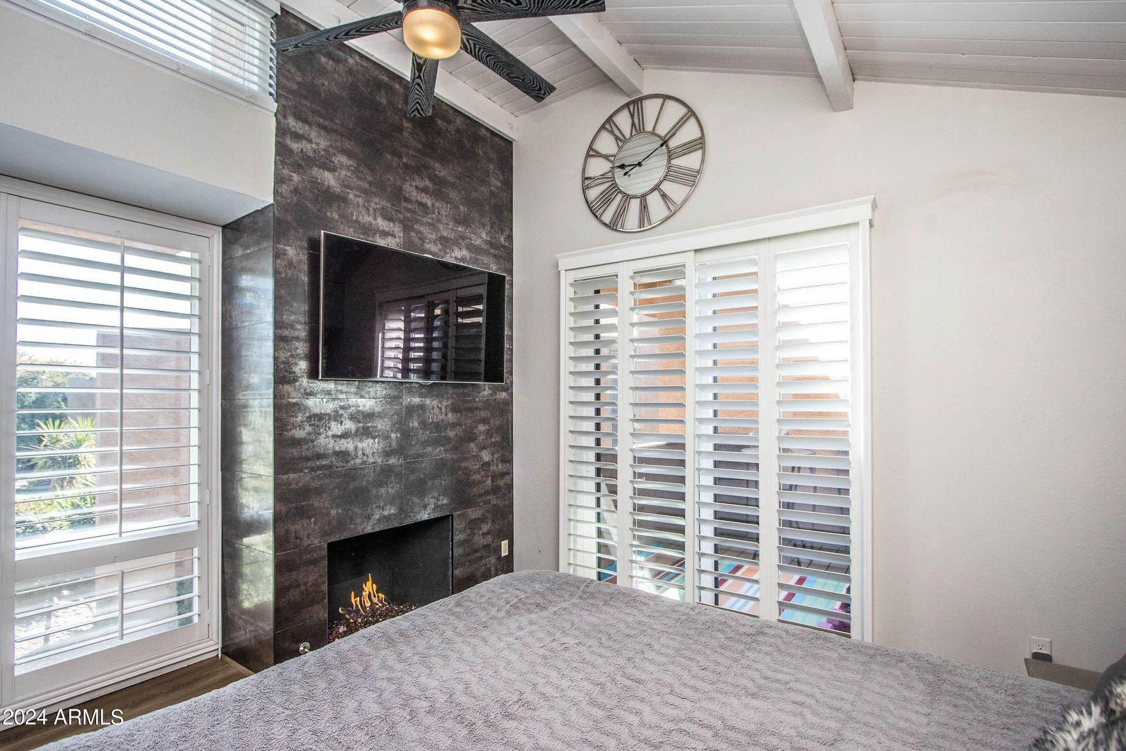 7401 North Scottsdale Road, Unit 3 Paradise Valley, AZ 85253 - Photo 8 of 29 a view of a livingroom with a fireplace and a window