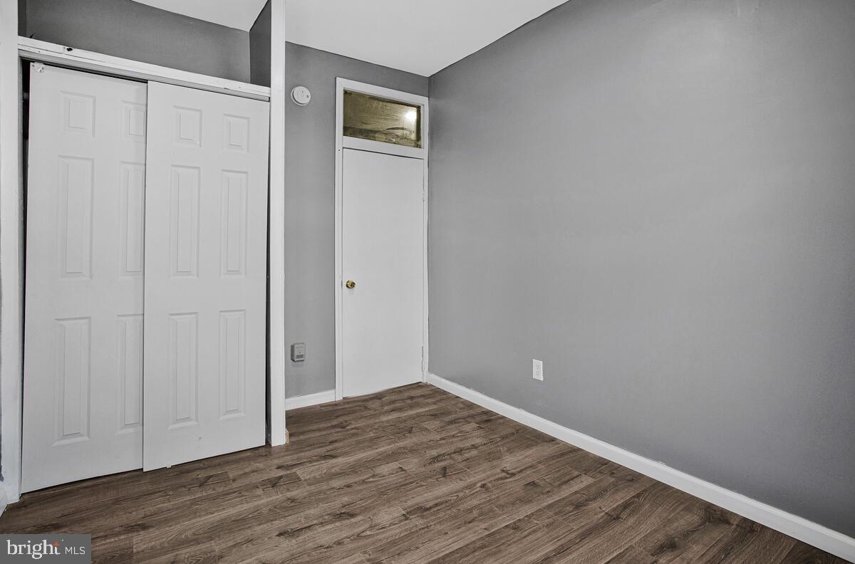 5204 Ivanhoe Avenue Baltimore, MD 21212 - Photo 23 of 38 a view of an empty room with wooden floor and closet
