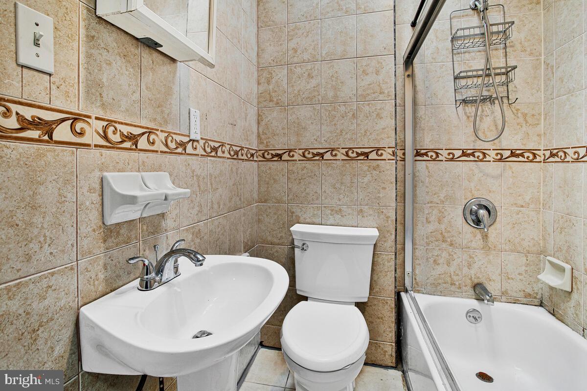 5204 Ivanhoe Avenue Baltimore, MD 21212 - Photo 24 of 38 a white toilet sitting next to a bathroom sink