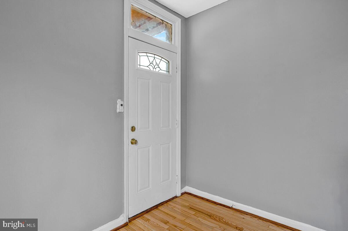 5204 Ivanhoe Avenue Baltimore, MD 21212 - Photo 5 of 38 a view of a hallway with wooden floor