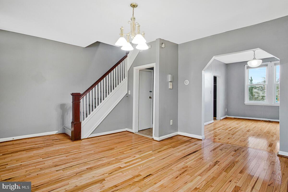 5204 Ivanhoe Avenue Baltimore, MD 21212 - Photo 7 of 38 a view of a room with wooden floor and staircase