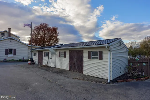 a front view of a house with garden and porch