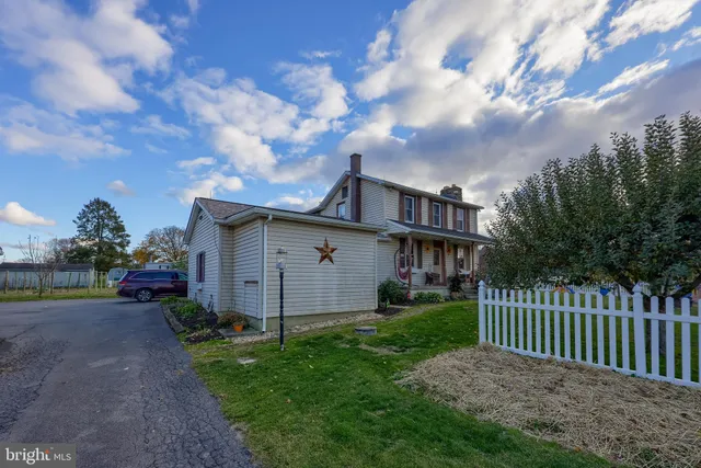 a front view of a house with a garden and plants