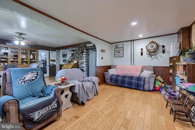 a kitchen with stainless steel appliances granite countertop a kitchen island hardwood floor and a sink