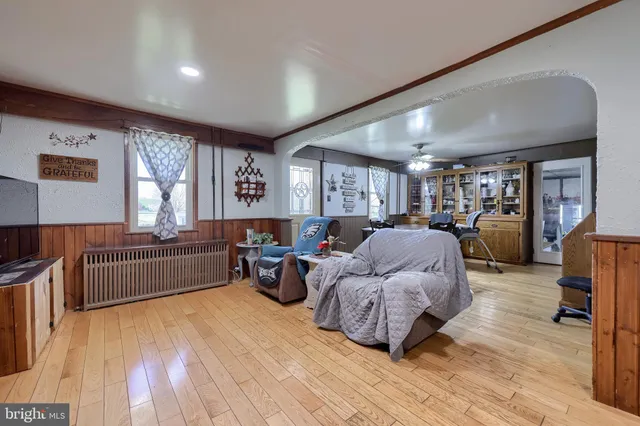 a kitchen with stainless steel appliances kitchen island granite countertop a table chairs in it and wooden floors