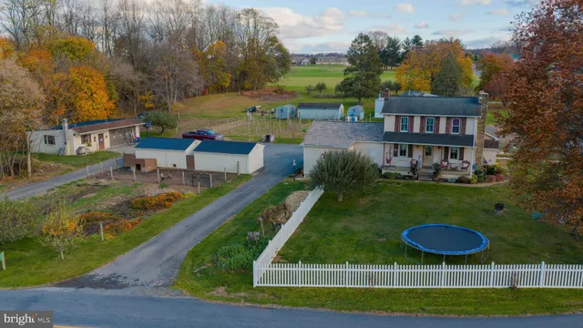 a view of a swimming pool with lawn chairs and a yard