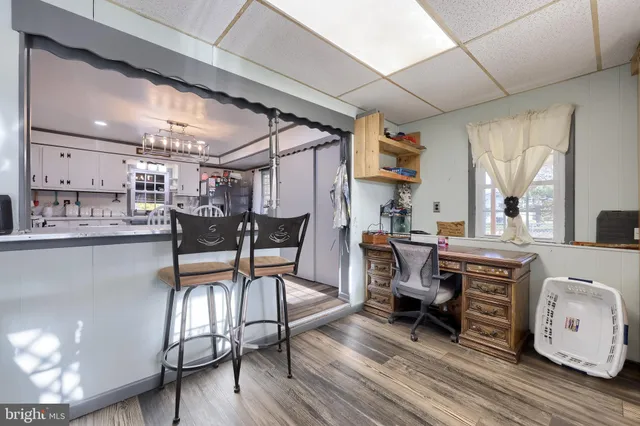 a living room with lots of furniture and kitchen view