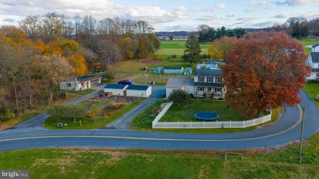 an aerial view of a house with outdoor space lake view and mountain view in back