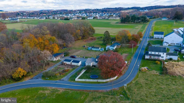 an aerial view of a house with outdoor space lake view and mountain view in back