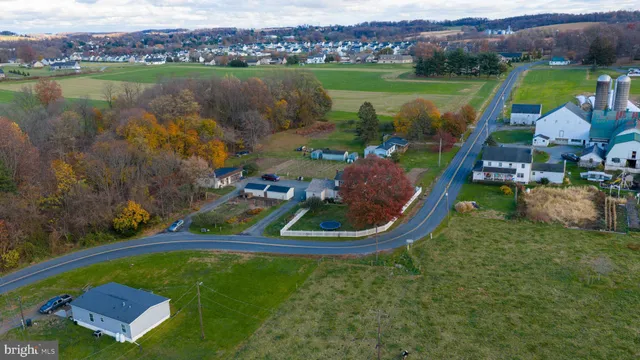 an aerial view of a house with outdoor space lake view and mountain view in back