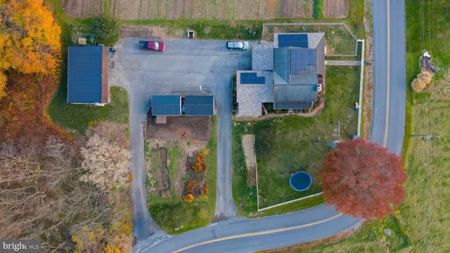 an aerial view of residential houses with outdoor space and river