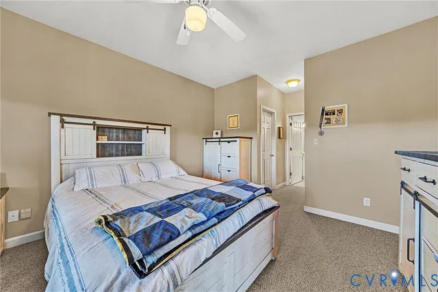 a bedroom with a bed and dresser with mirror