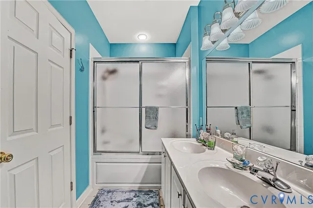 a bedroom with a bed and a dresser next to a window