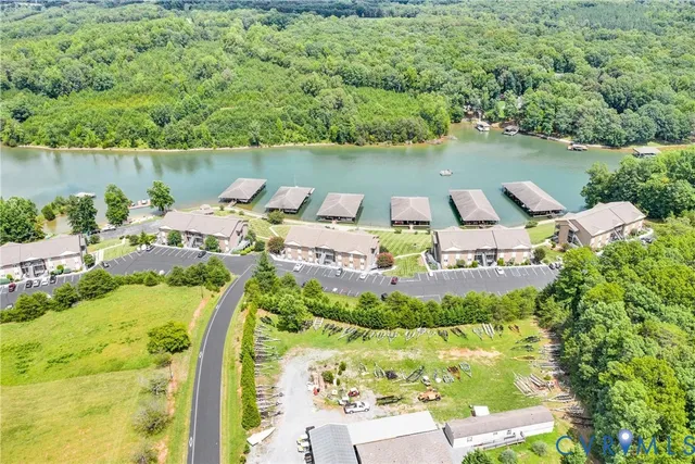 an aerial view of a house with outdoor space and lake view