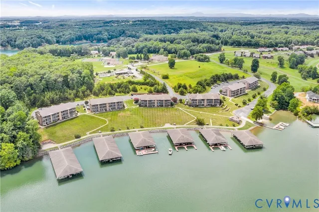 an aerial view of a house with outdoor space and lake view
