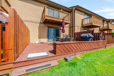 a view of a balcony with yard