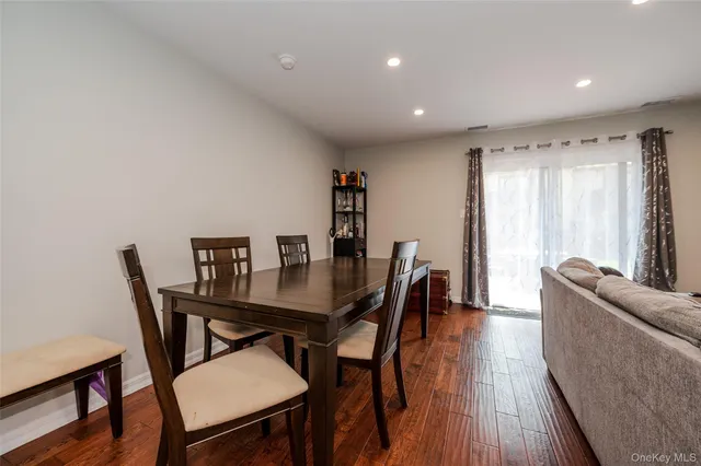 a view of a a dining room with furniture window and wooden floor