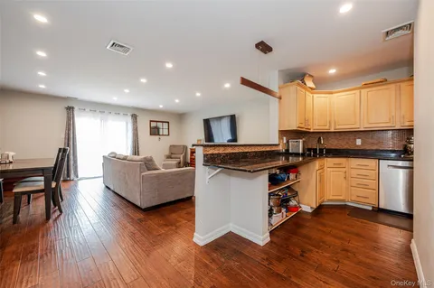 a view of backyard with large trees and wooden fence