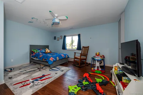 a bedroom with a large bed and a chandelier